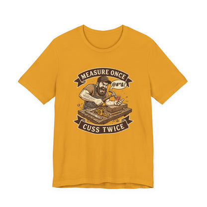 A mustard yellow short-sleeve t-shirt with a graphic print of a bearded man smoking a joint, with banners reading 'MEASURE ONCE' and 'CUSS TWICE'.